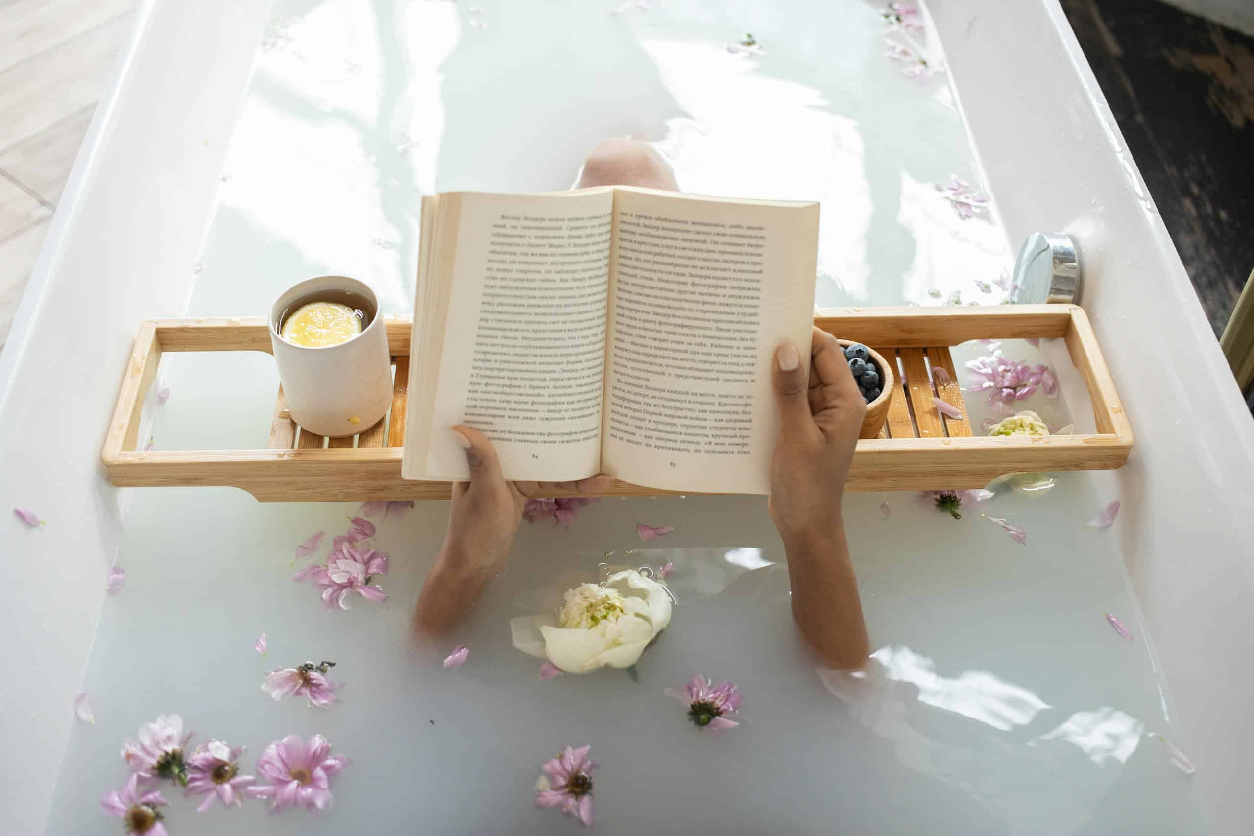 Woman enjoying DIY milk bath with freeze dried milk while reading and relaxing